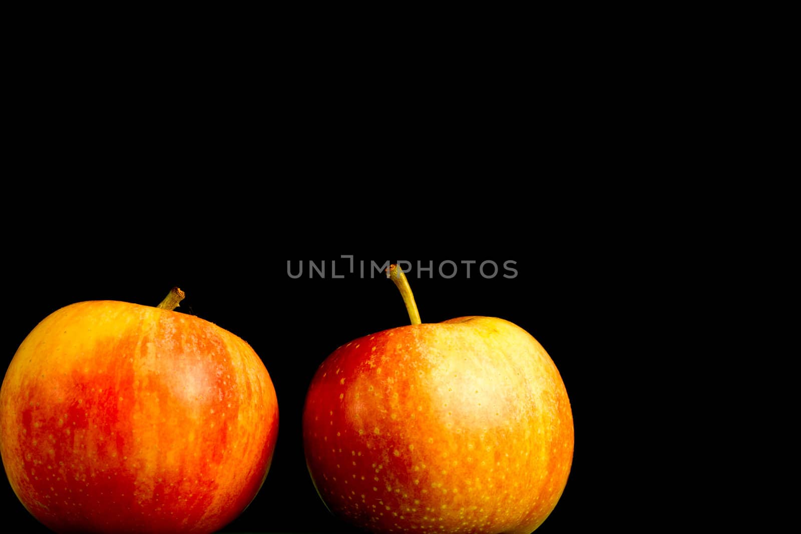 Apples in a row on black backround