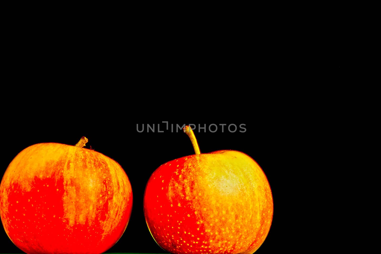 Apples in a row on black backround