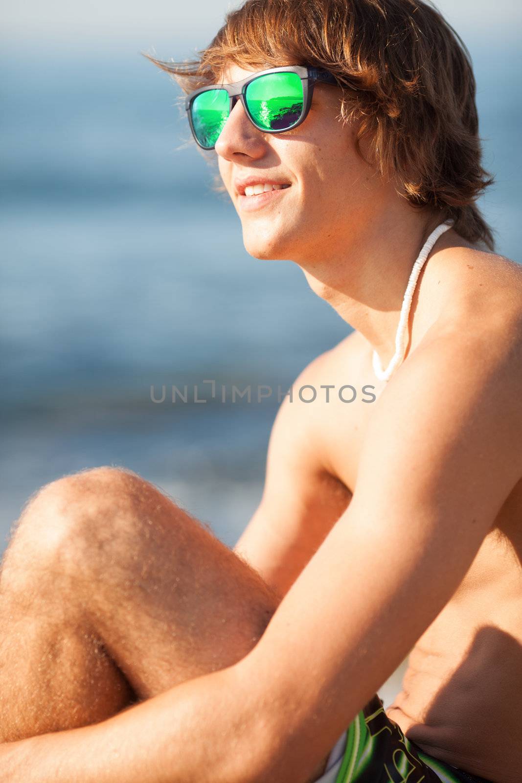 young healthy beautiful men portrait laughing on the beach by Lcrespi