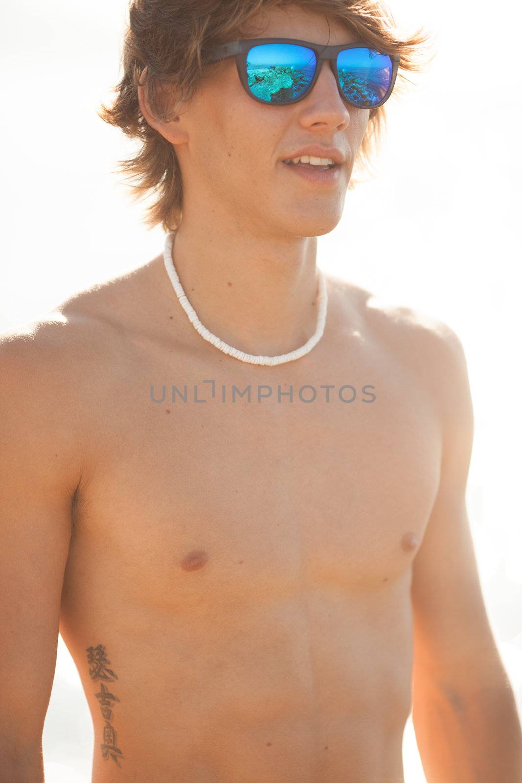 young healthy beautiful men portrait laughing on the beach