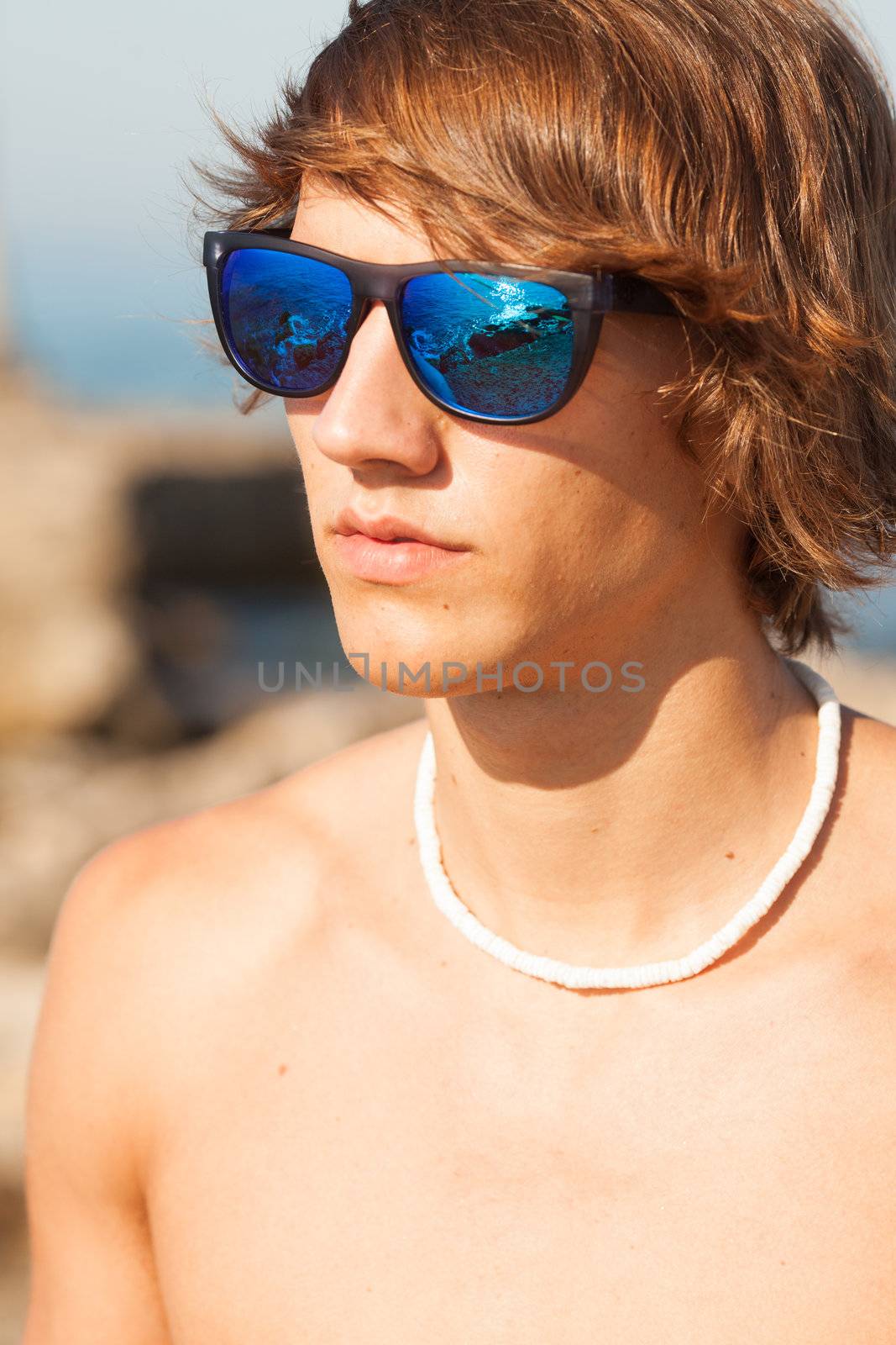 young healthy beautiful men portrait laughing on the beach by Lcrespi