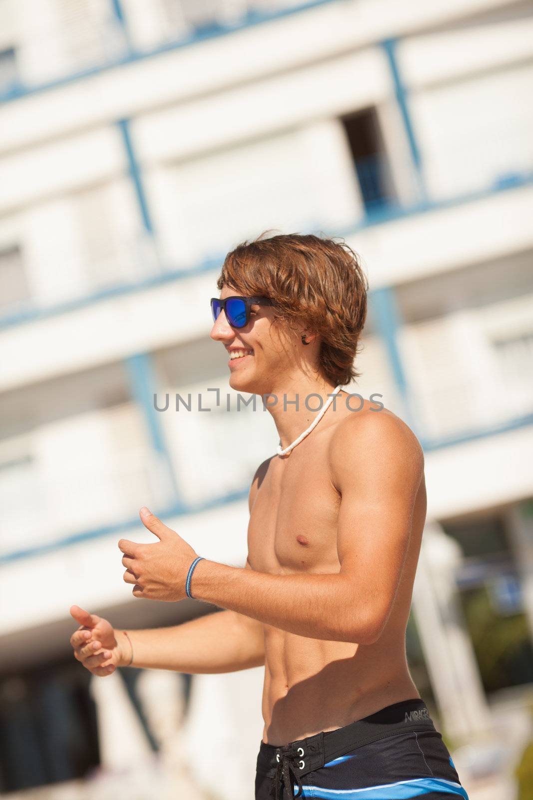 young healthy beautiful men portrait laughing on the beach