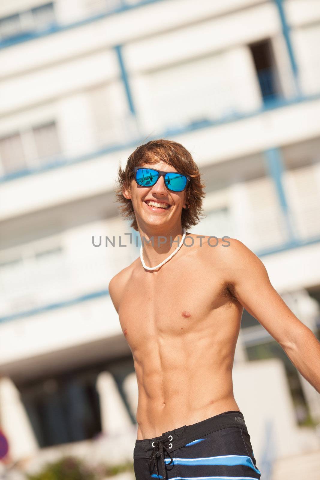 young healthy beautiful men portrait laughing on the beach