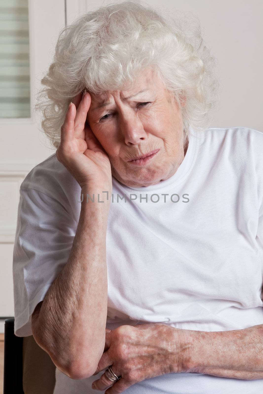 Senior Woman having Headache by leaf