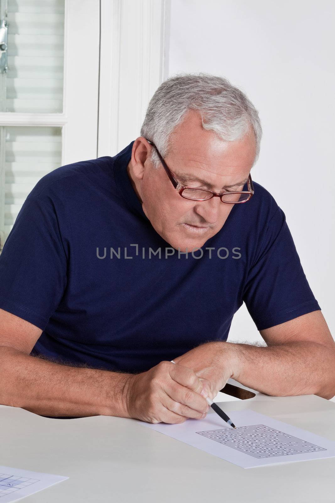 Portrait of mature man playing scrabble game.