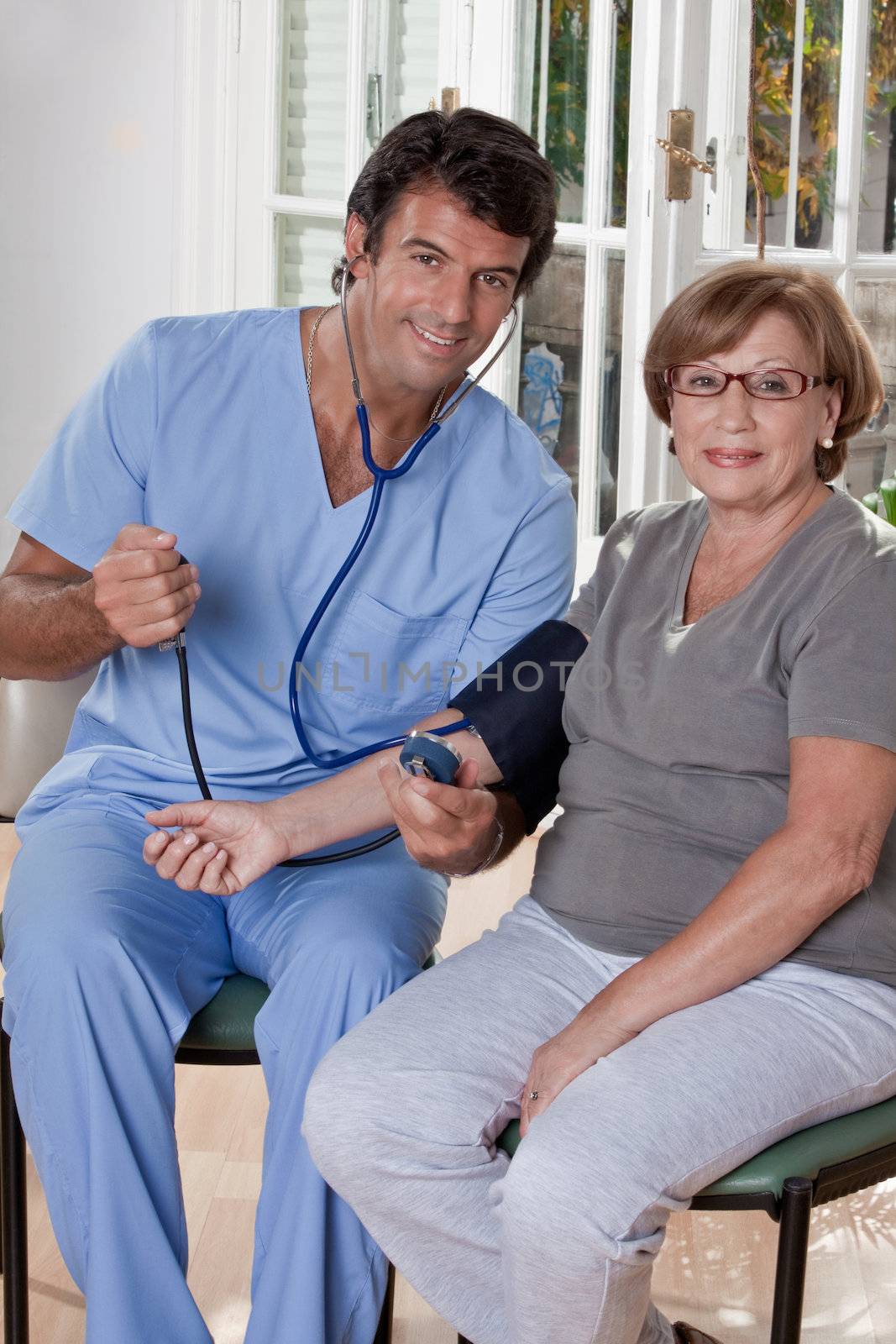 Doctor taking the blood pressure of a patient.