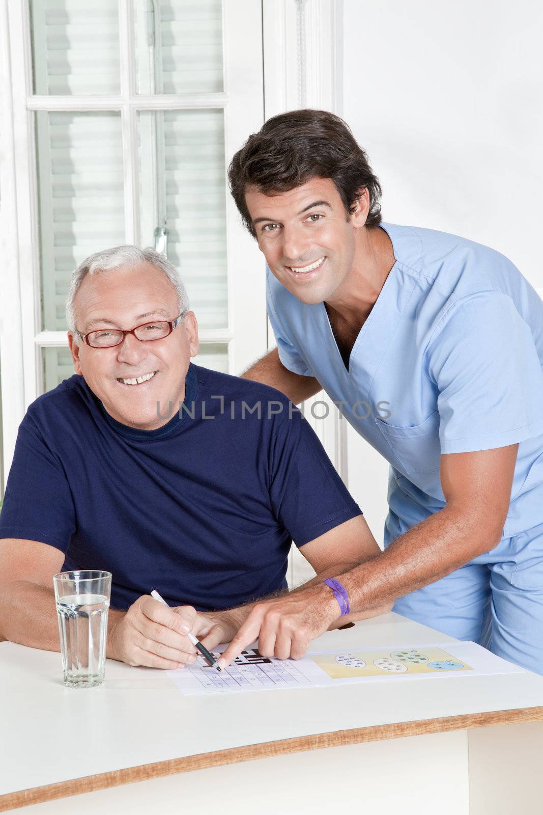Mature Man playing Sudoku Puzzle by leaf