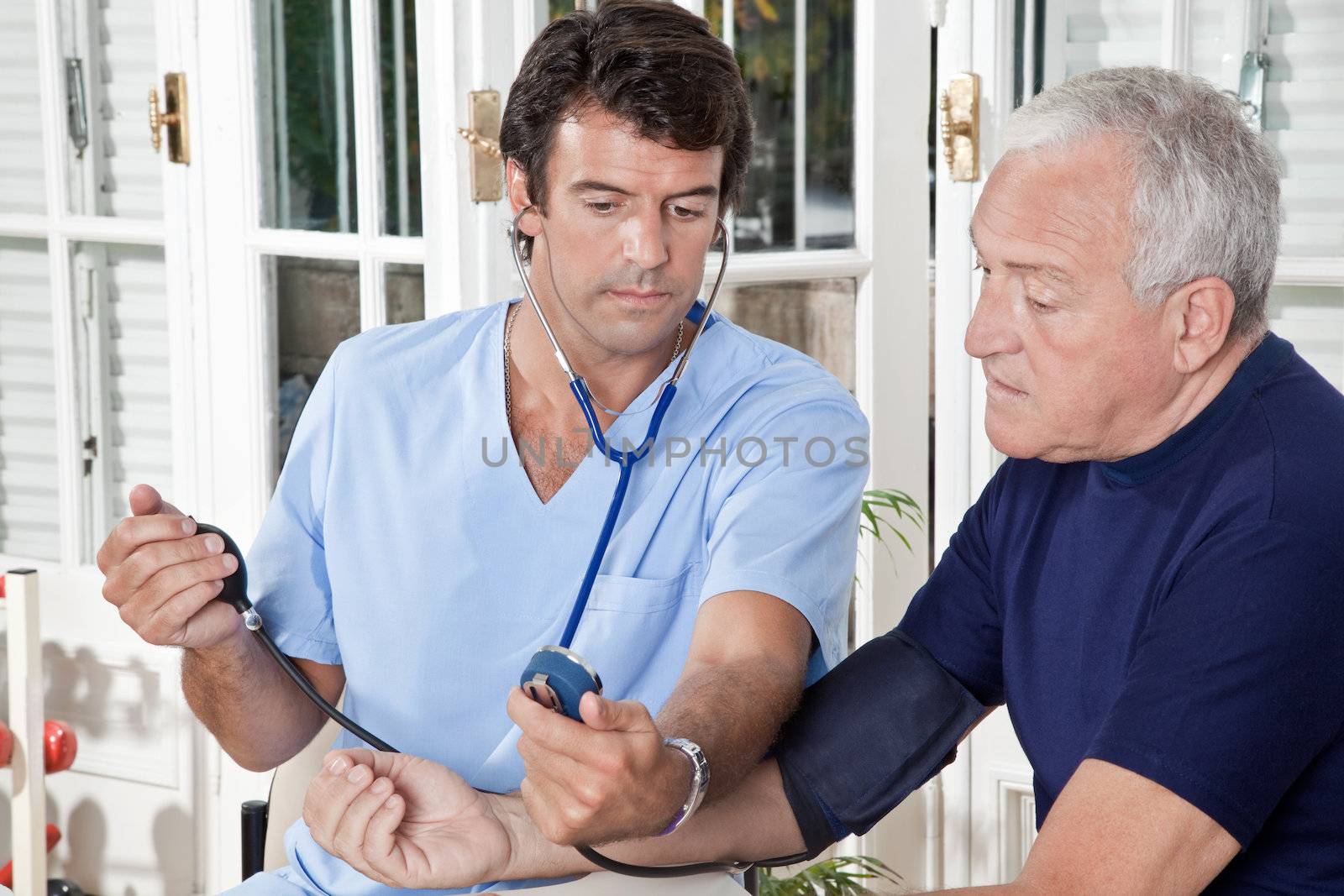 Doctor taking the blood pressure of a patient.