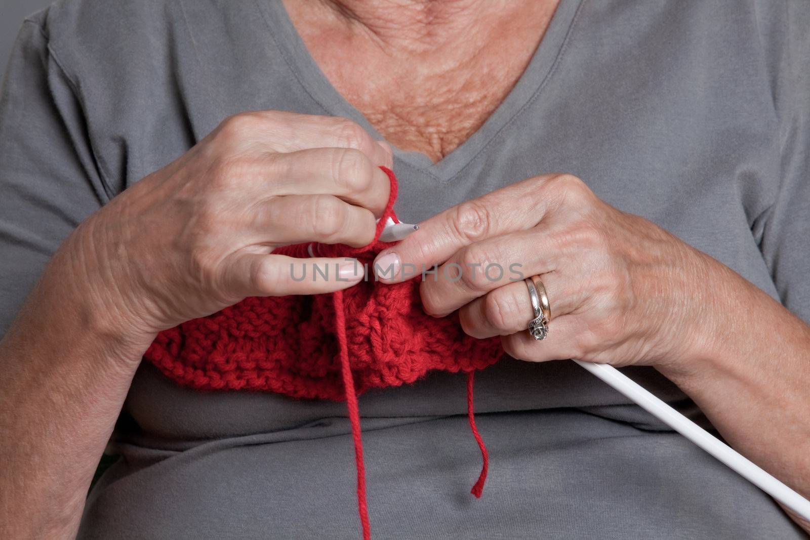 Senior Woman Knitting by leaf