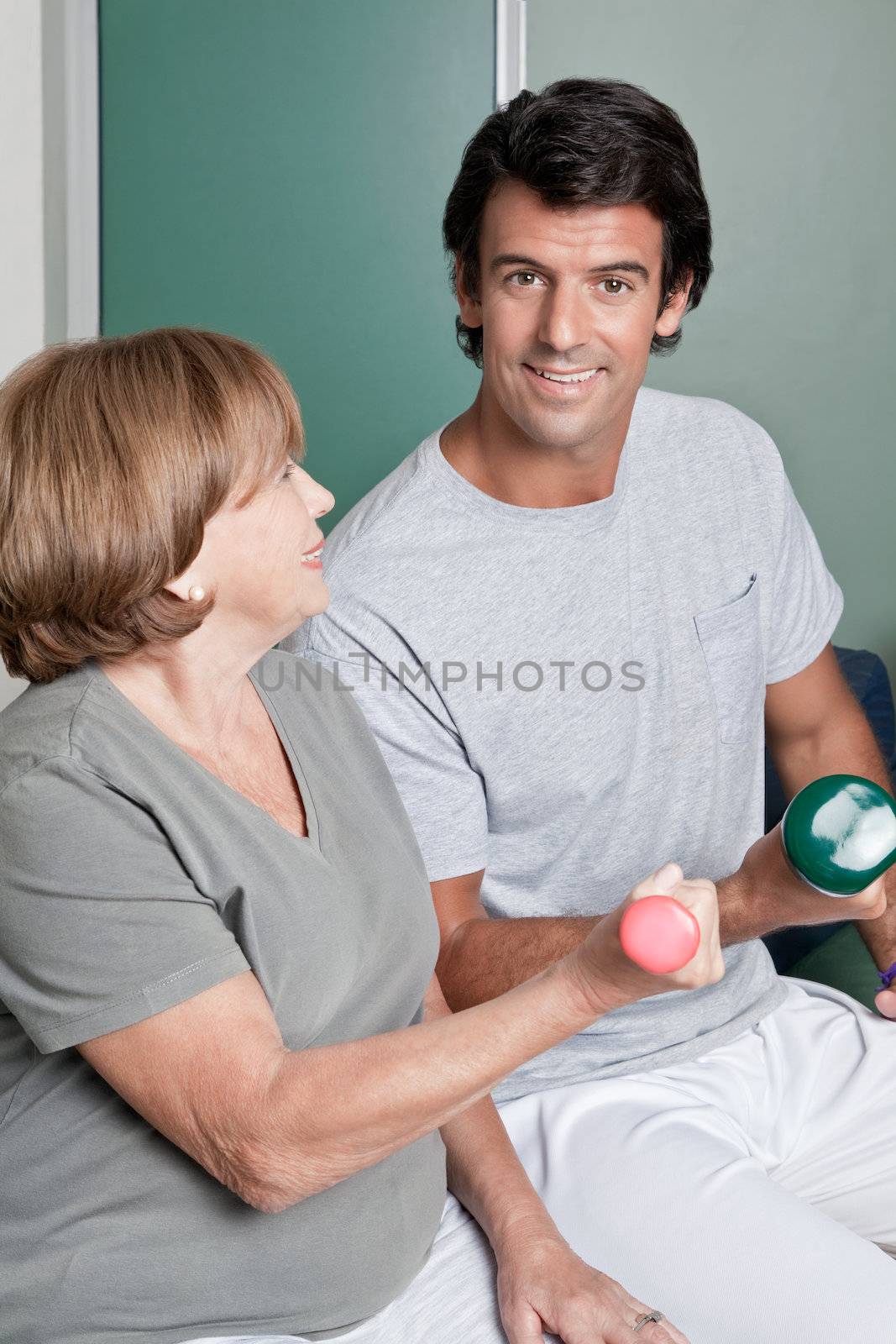 Young instructor and Woman Exercising by leaf