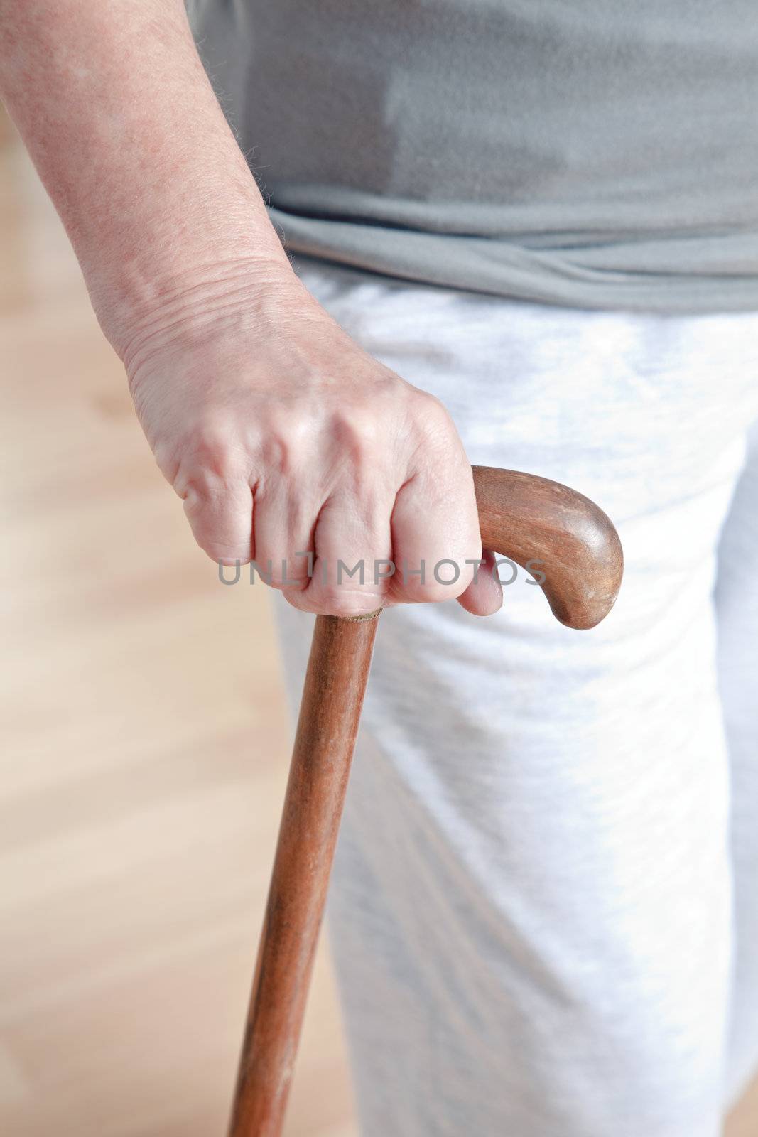 Elderly Woman with Walking Stick by leaf