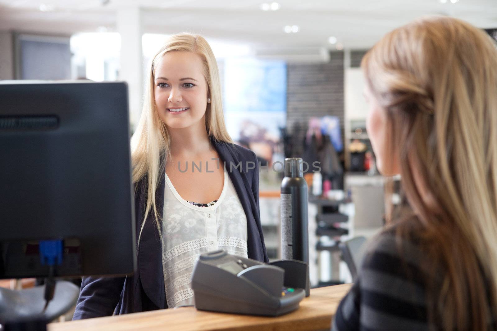 Receptionist Helping Customer at Beauty Salon by leaf