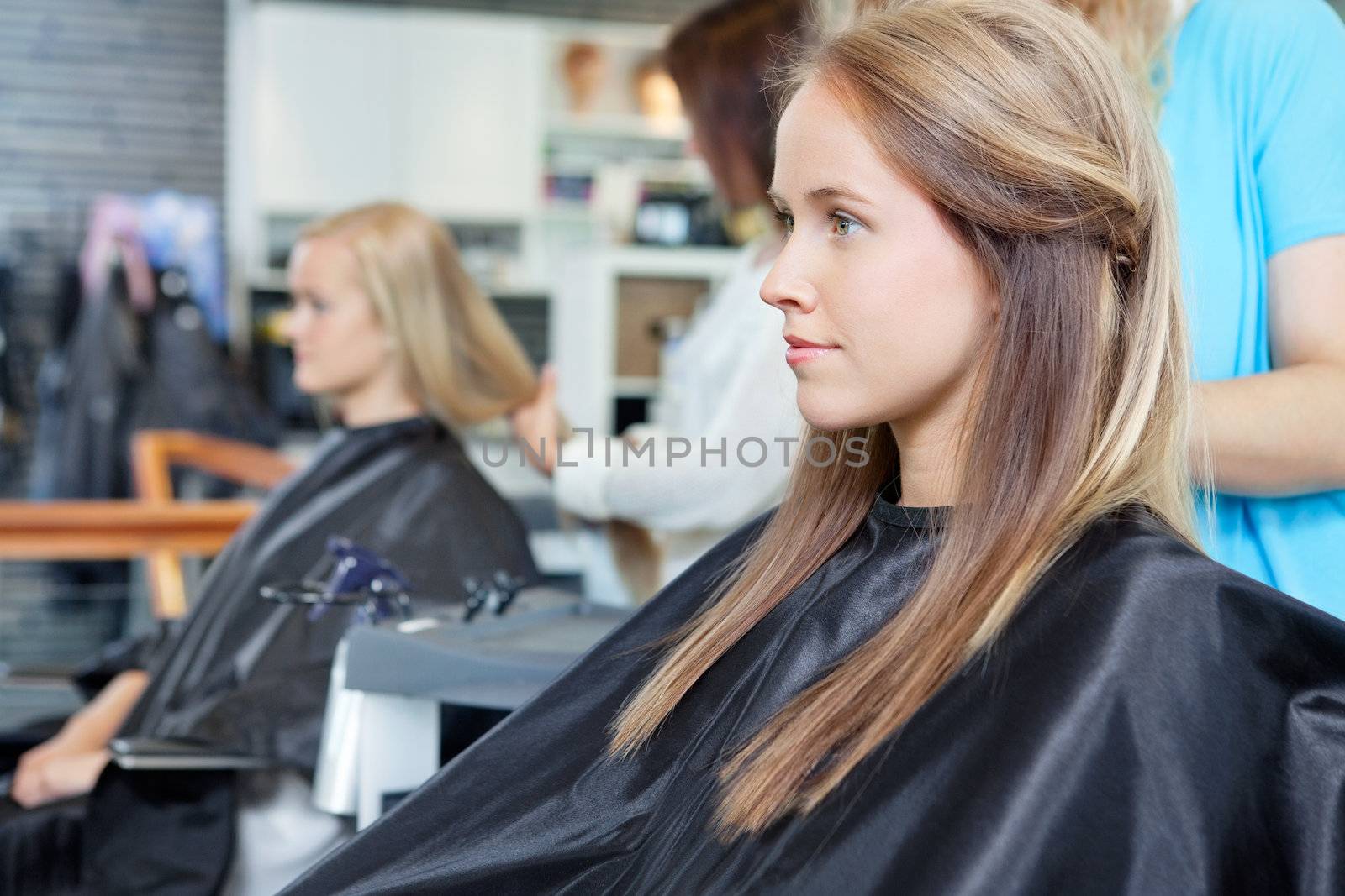 Beautiful young woman at parlor for haircut