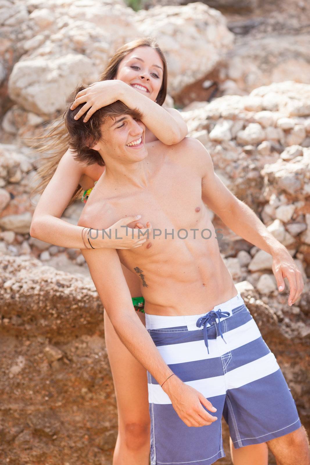 beautiful young couple having fun on the beach by Lcrespi