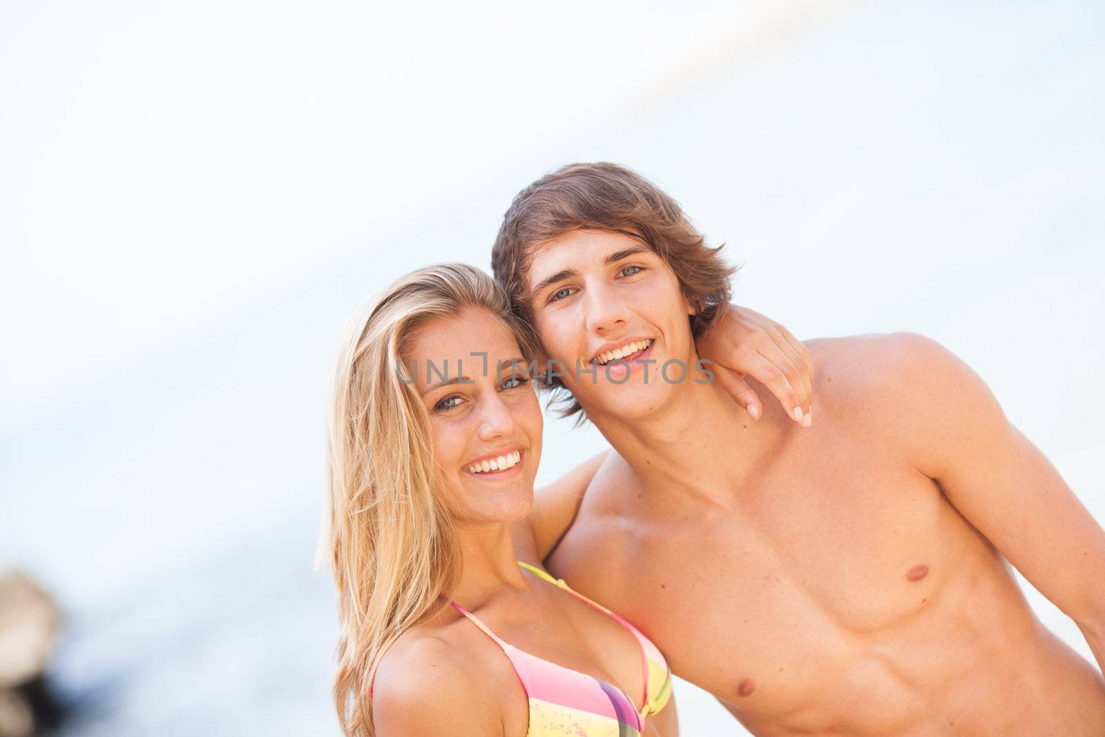 Young couple enjoying themselves at the beach by Lcrespi