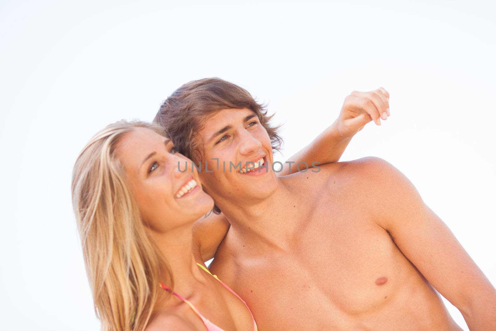 Young couple enjoying themselves at the beach by Lcrespi