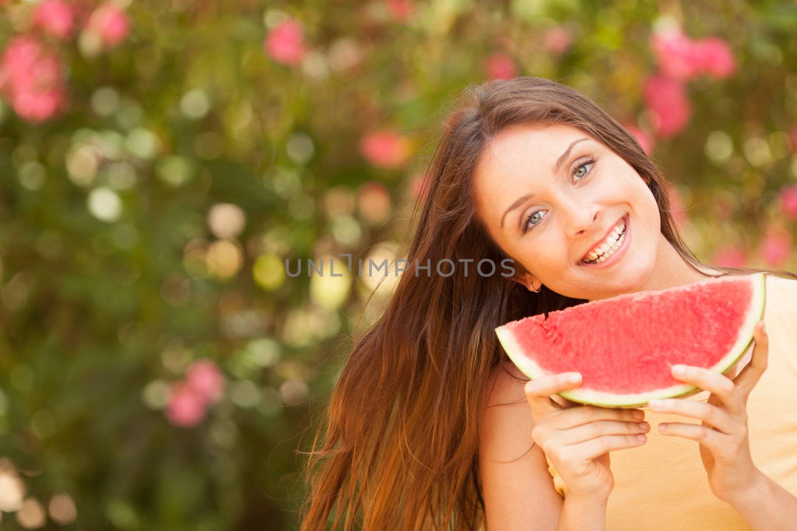 Portrait of a beautiful young woman eating watermelon by Lcrespi