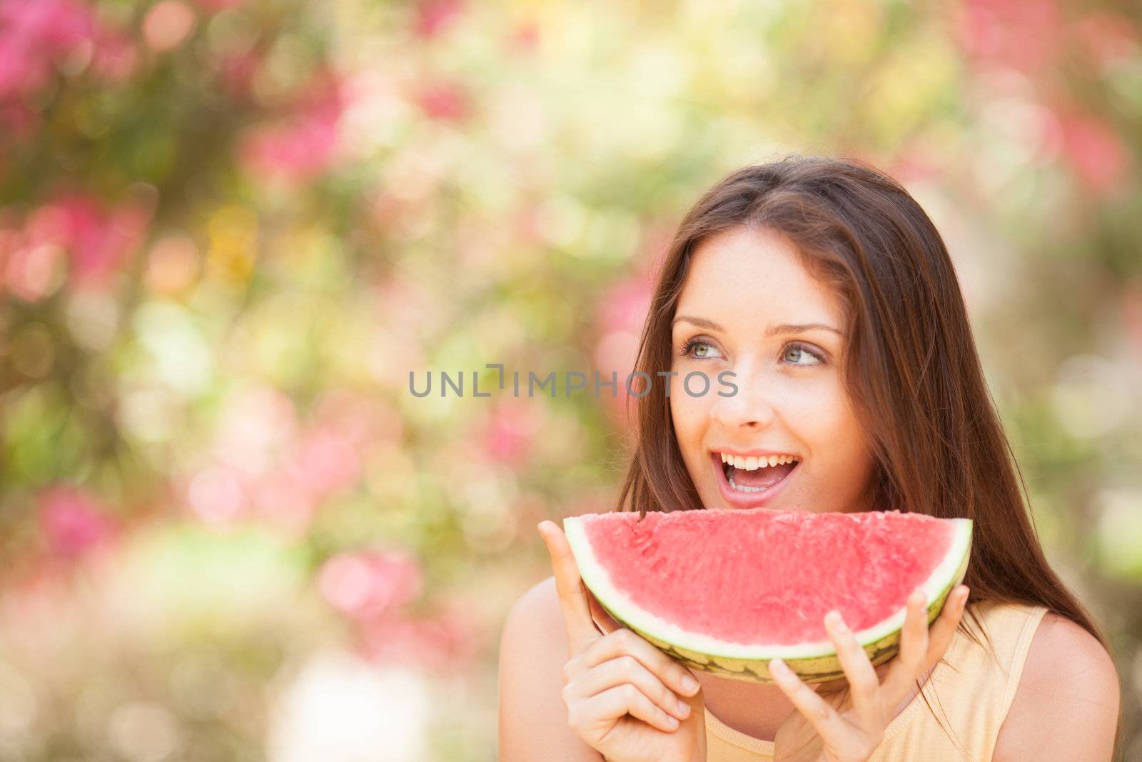 Portrait of a beautiful young woman eating watermelon by Lcrespi