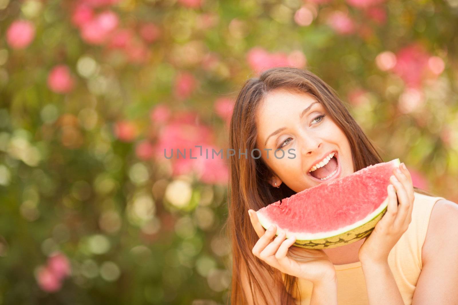 Portrait of a beautiful young woman eating watermelon by Lcrespi