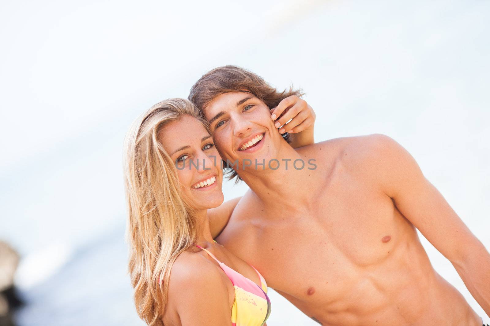 Young couple enjoying themselves at the beach by Lcrespi