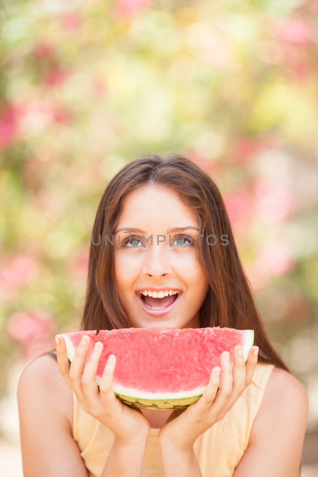 Portrait of a beautiful young woman eating watermelon