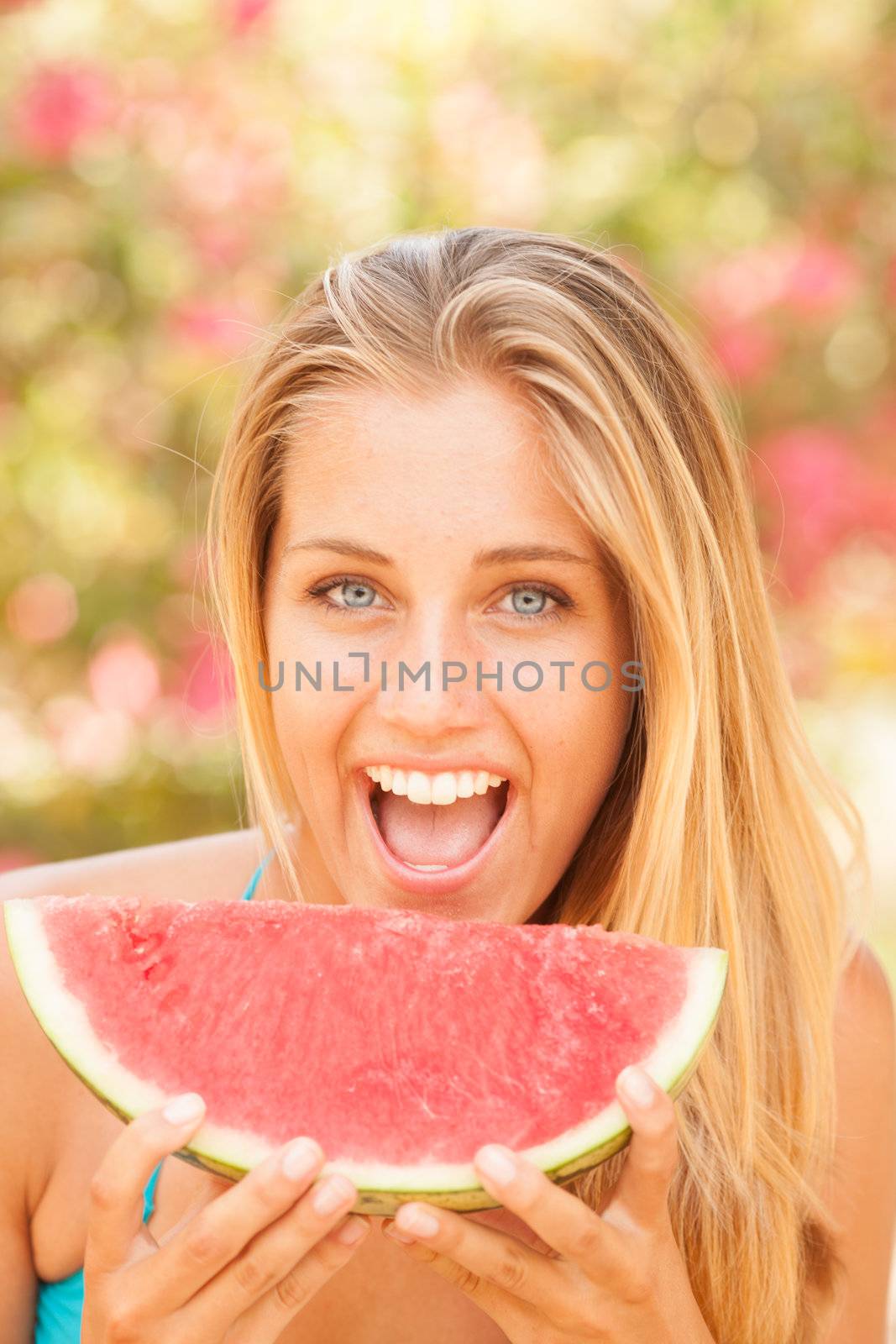 Portrait of a beautiful young woman eating watermelon