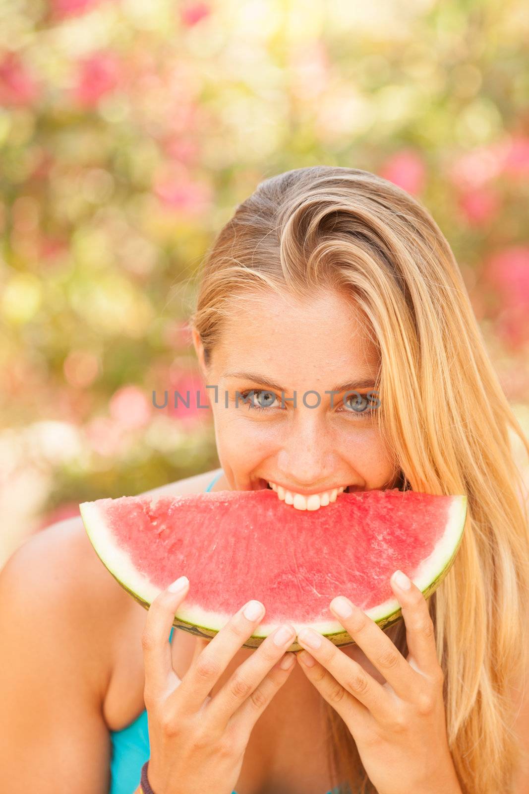 Portrait of a beautiful young woman eating watermelon