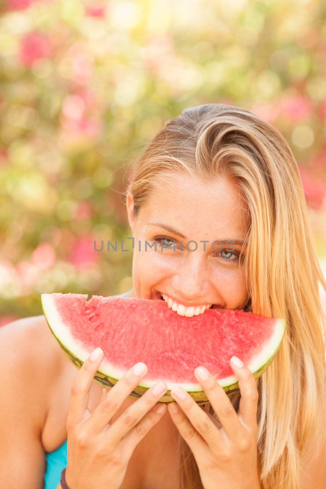 Portrait of a beautiful young woman eating watermelon