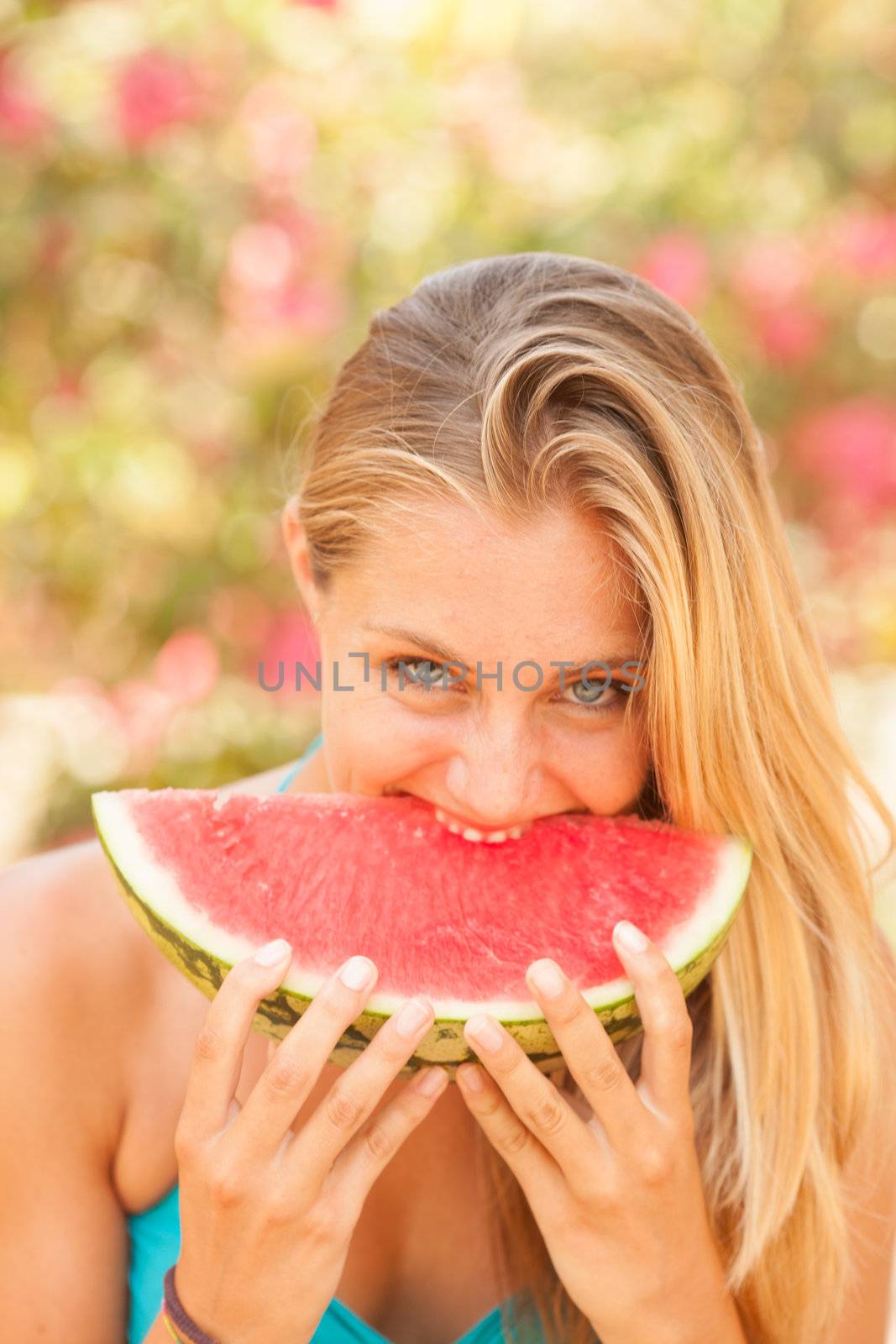 Portrait of a beautiful young woman eating watermelon