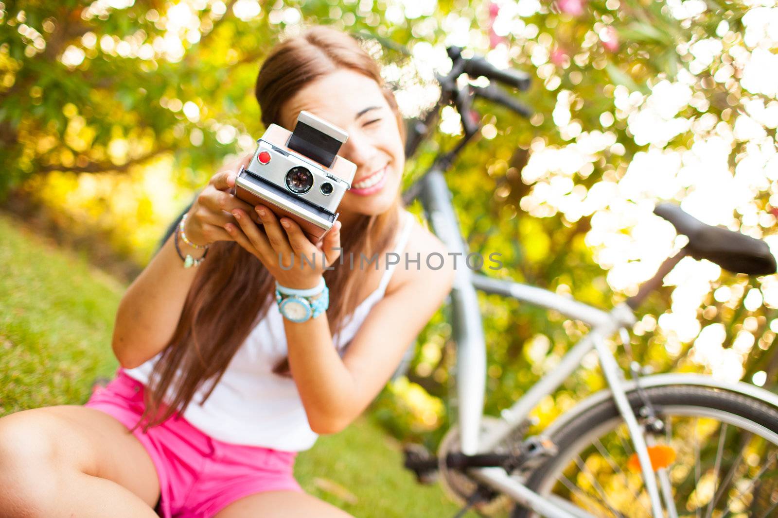beautiful young woman playing with a vintage camera