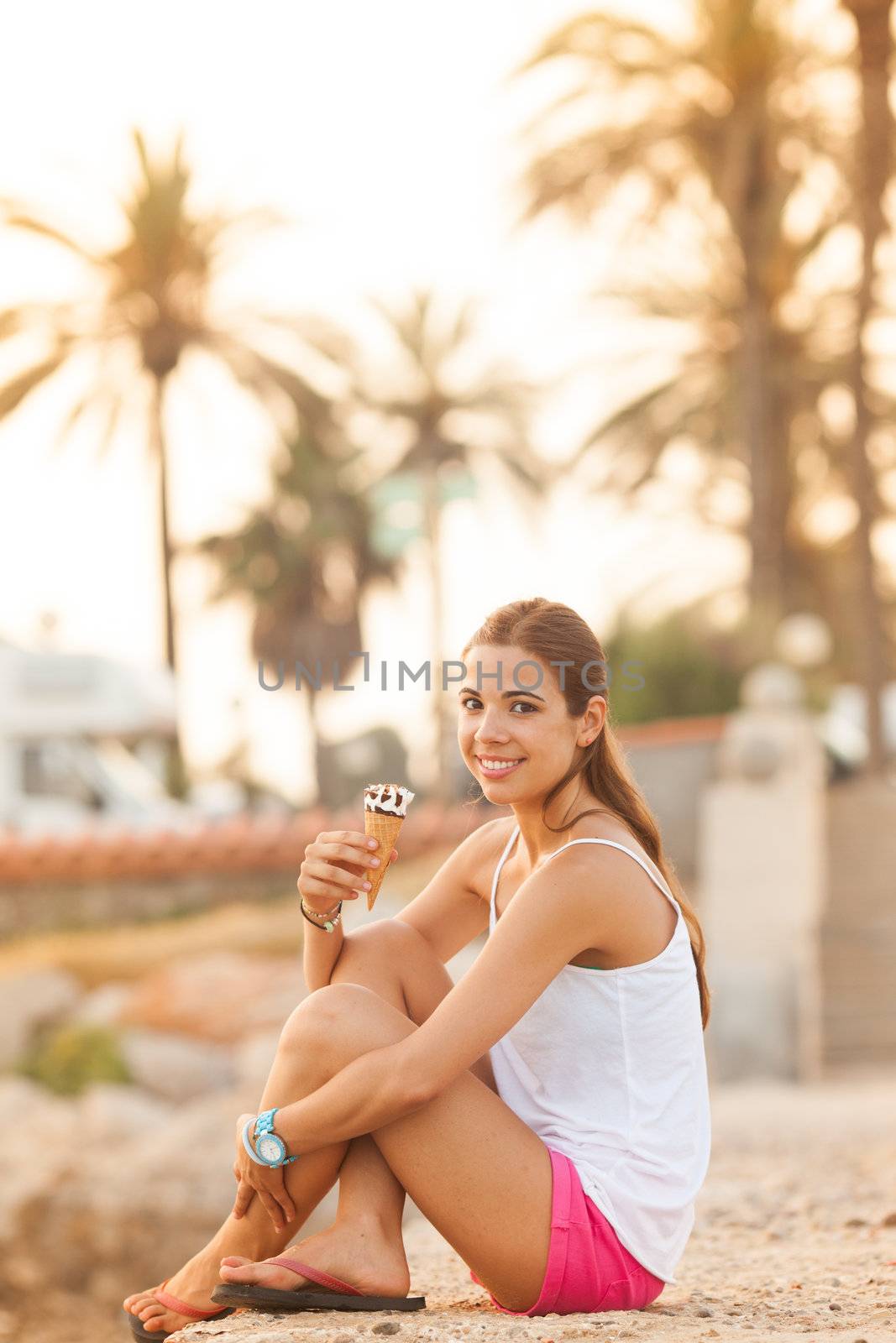 portrait of a young beautiful woman eating ice-cream cone