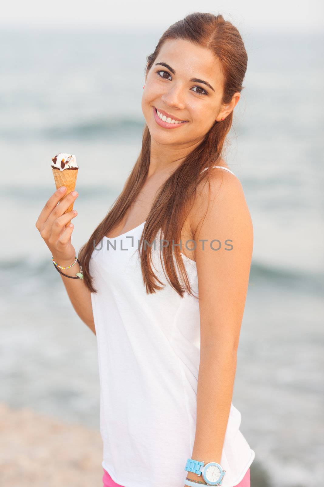 portrait of a young beautiful woman eating ice-cream cone by Lcrespi