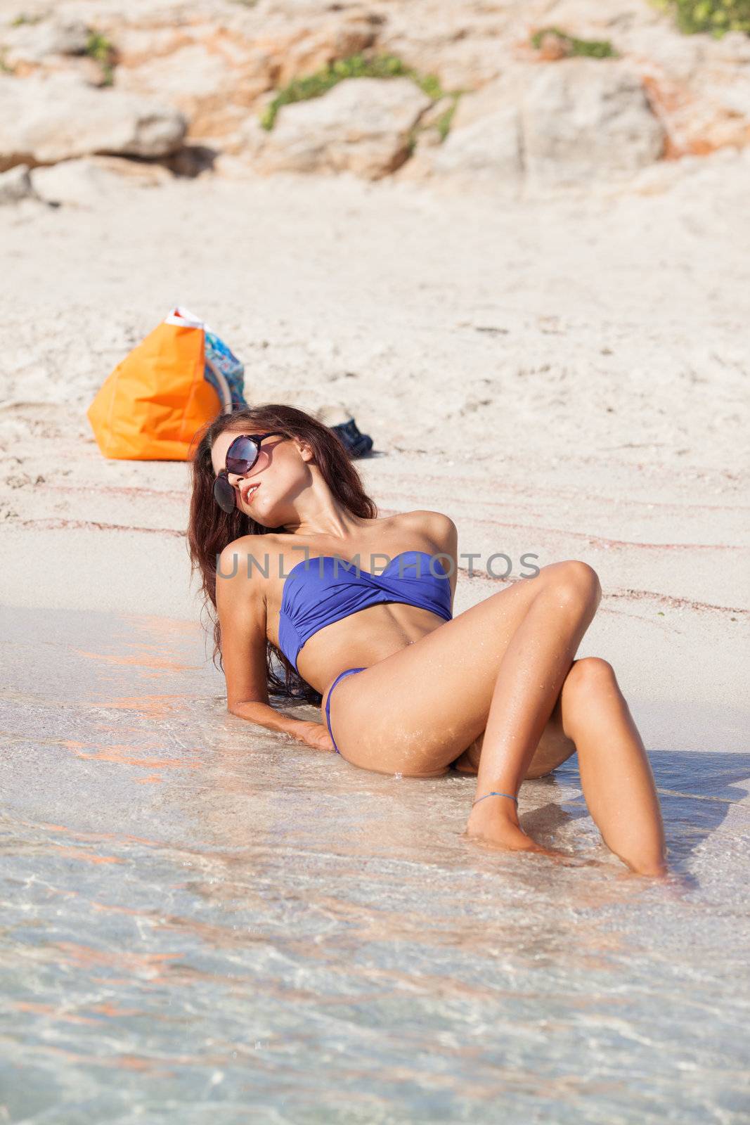 sexy beautiful model laying on vacation. having fun on shore
