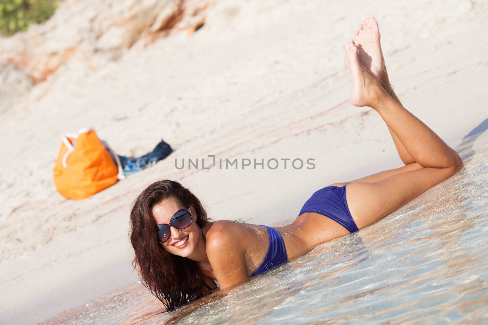 sexy beautiful model laying. having fun on shore by Lcrespi