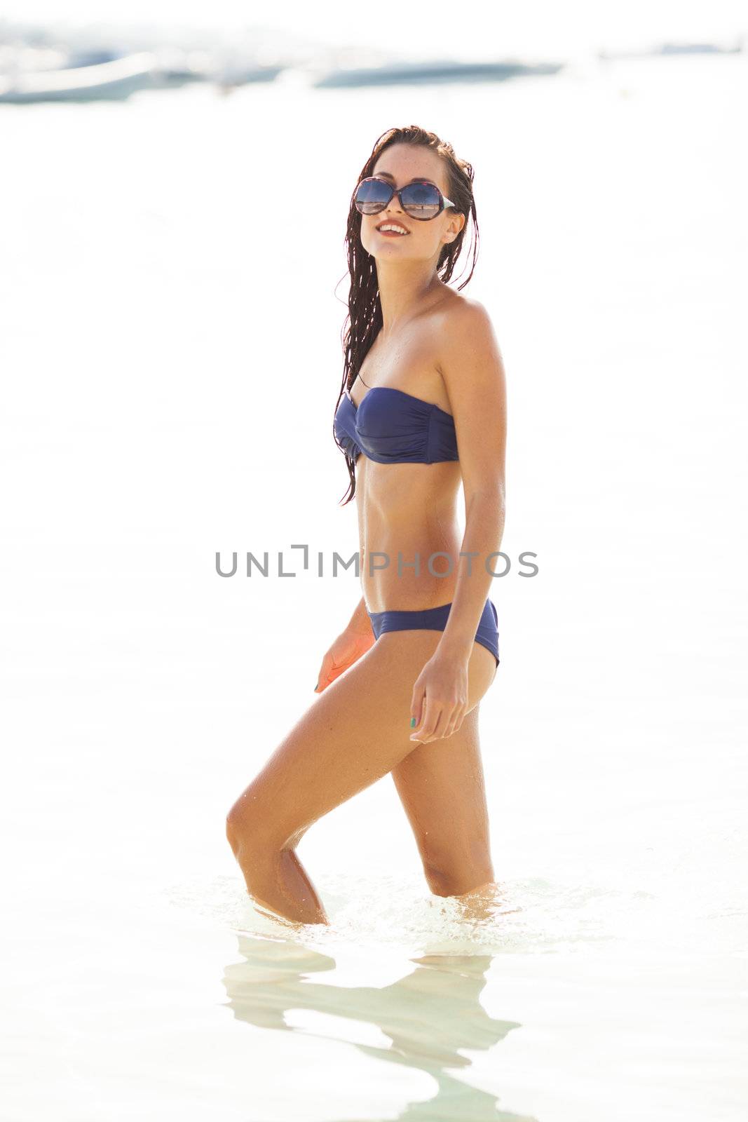 sexy beautiful model on bikini posing in the water