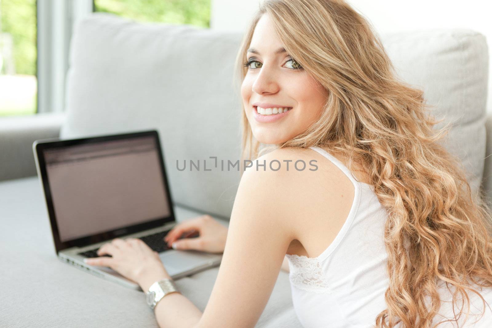 young beautiful woman using laptop by Lcrespi