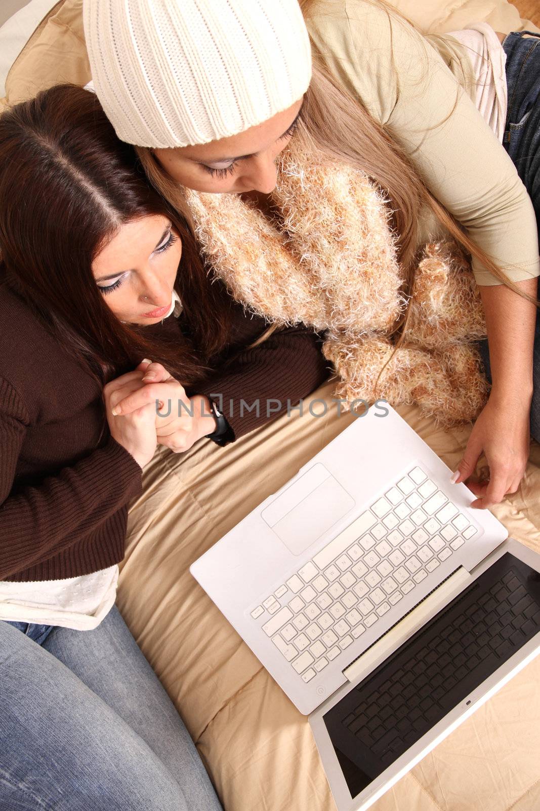 Two girls planning their winter holidays online.