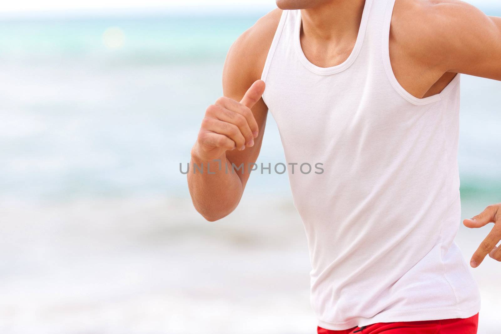 man chest closep jogging on the beach white t-shirt