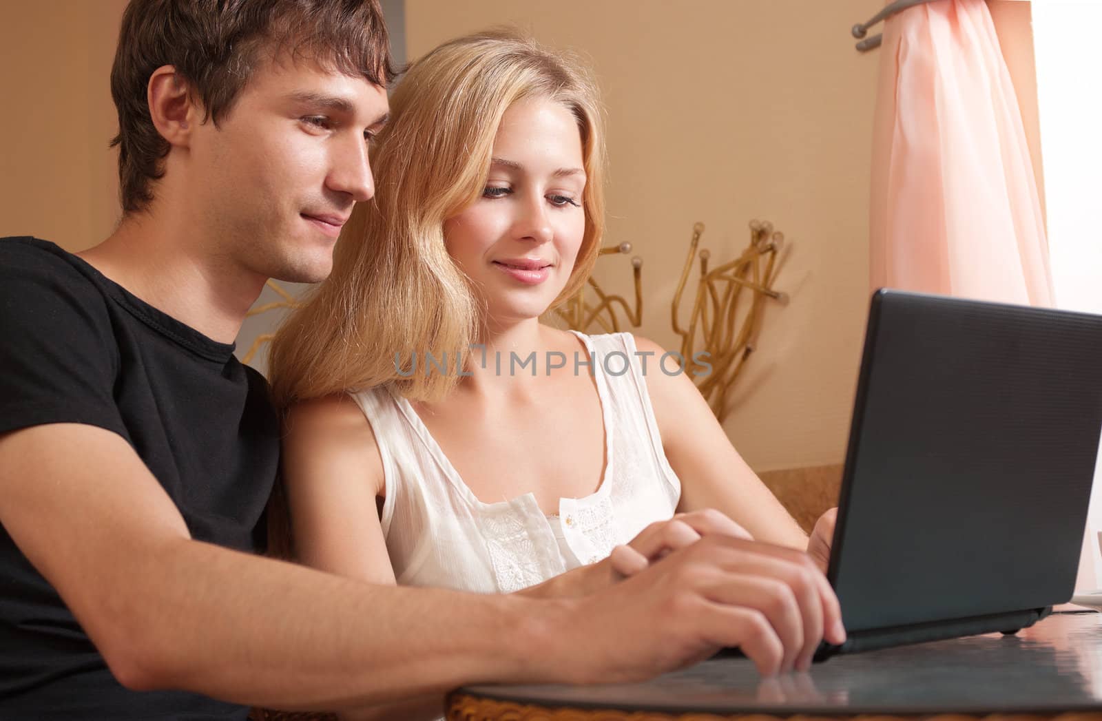 Young couple in the cafe with laptop