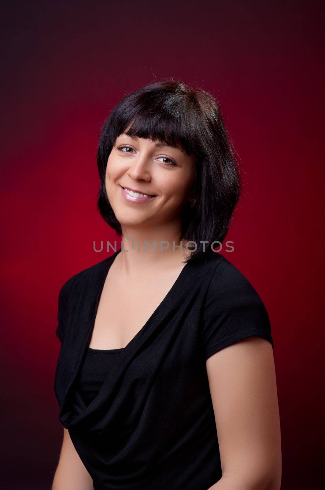 Portrait of young woman on red background