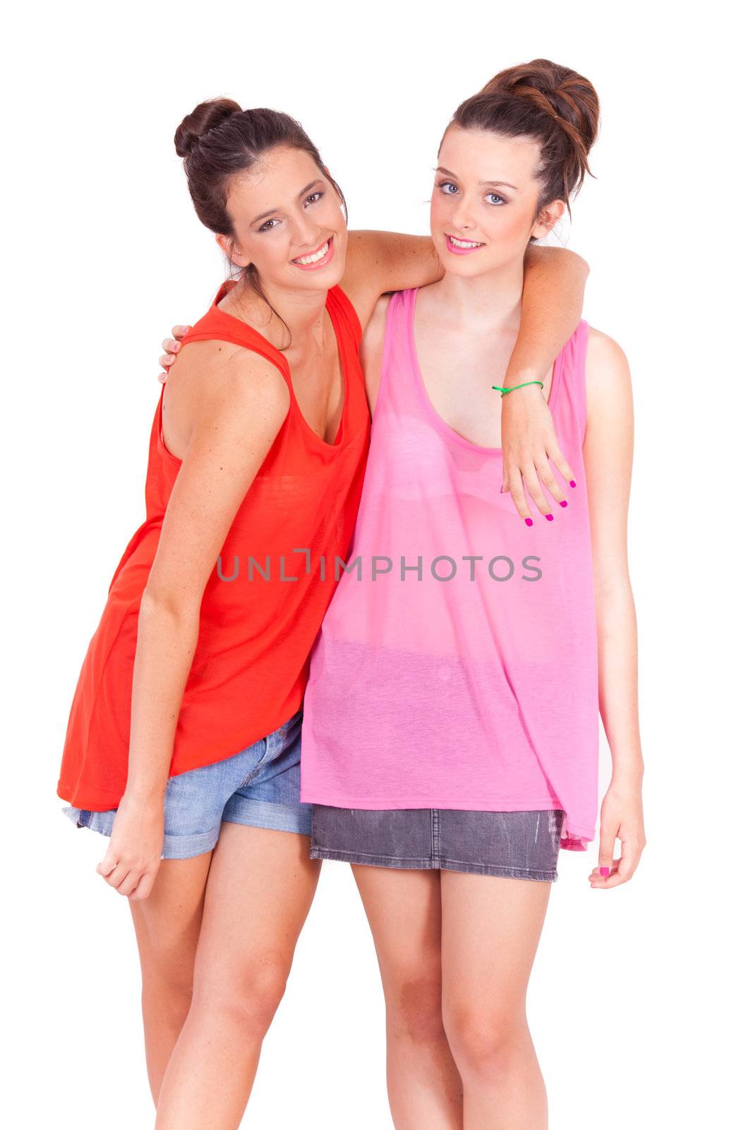 young couple female friends laughing on white background