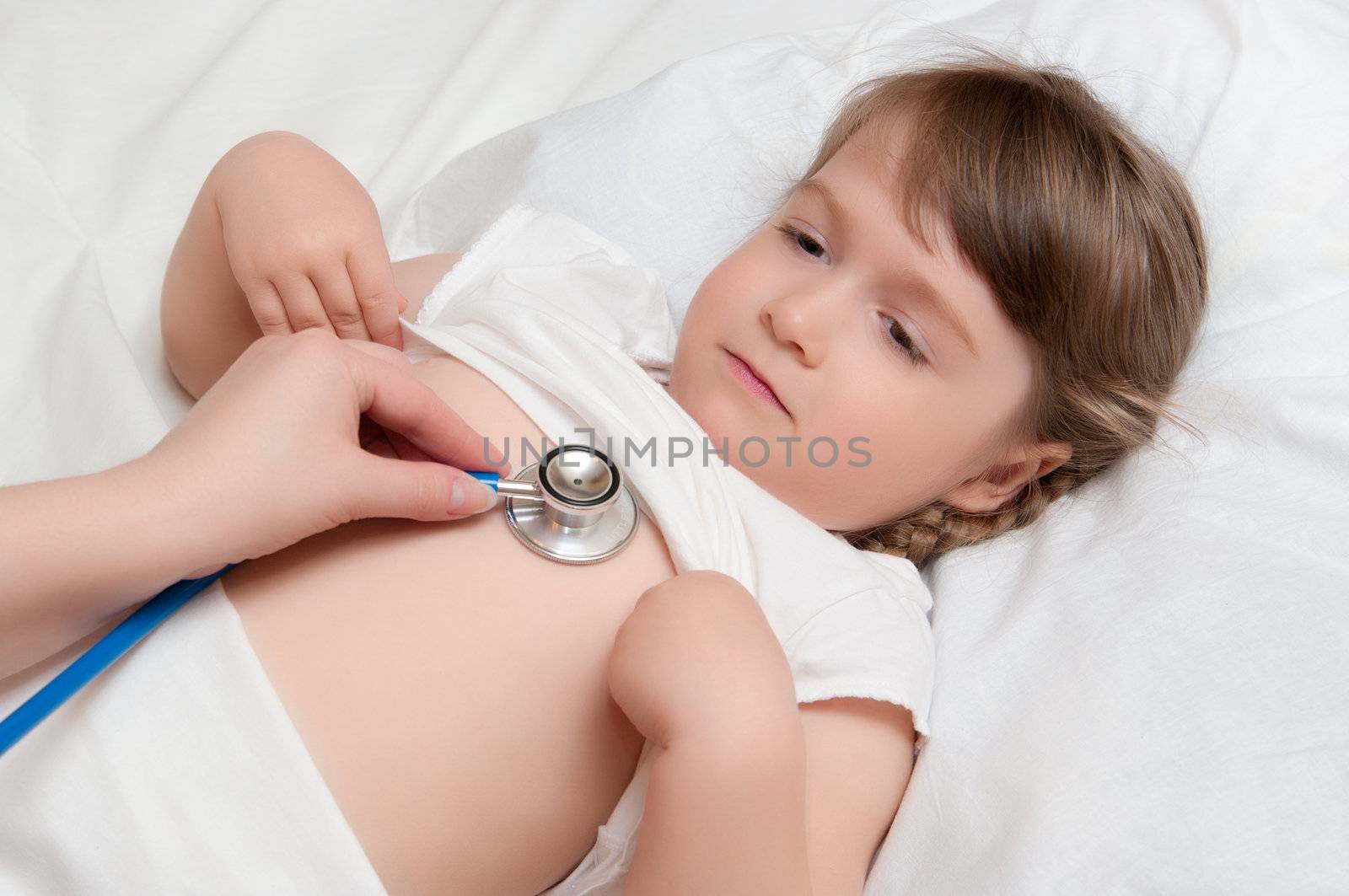 Listening of little girl by stethoscope