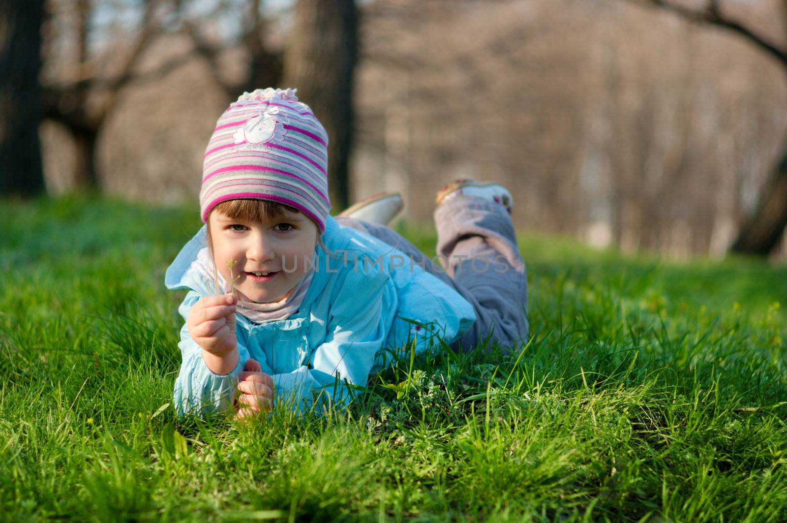 Little smiling little girl at spring forest