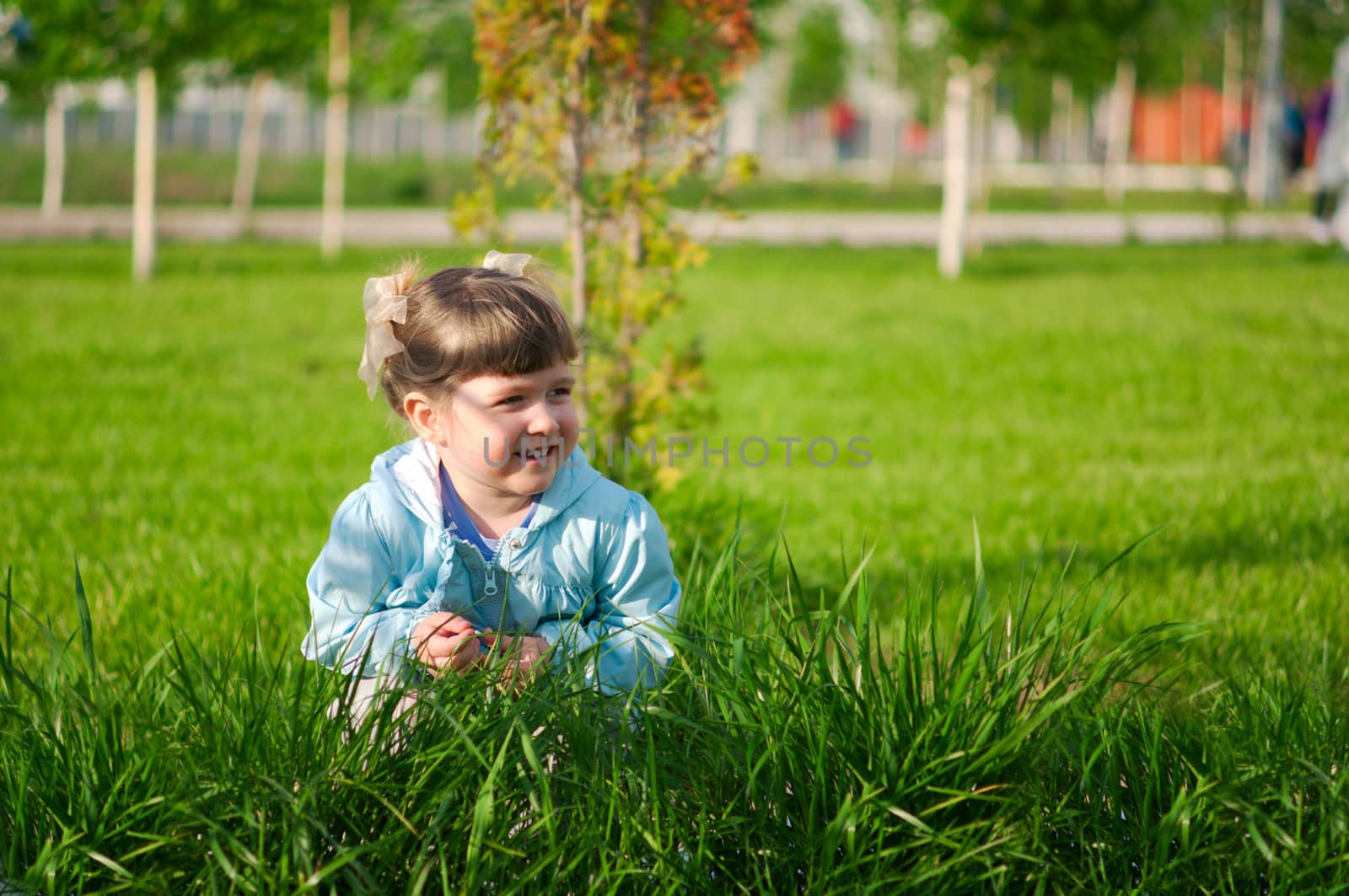 Little smiling girl in a park