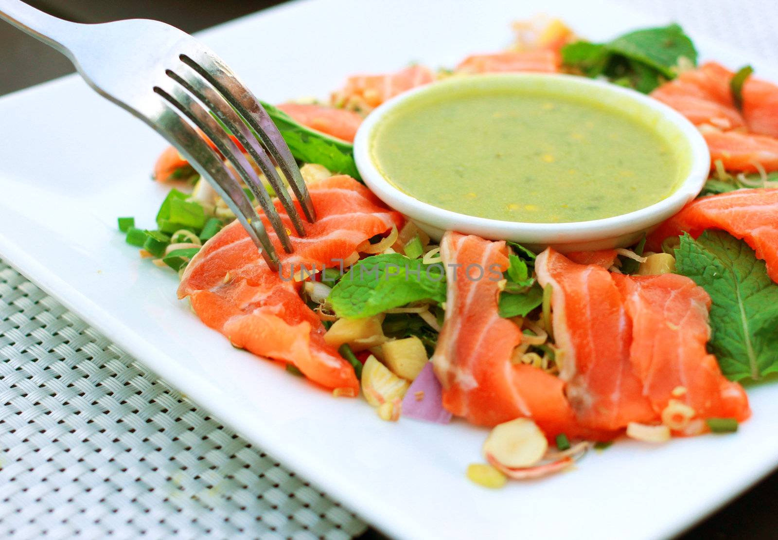 Spicy salmon salad and wasabi sauce with fork by nuchylee