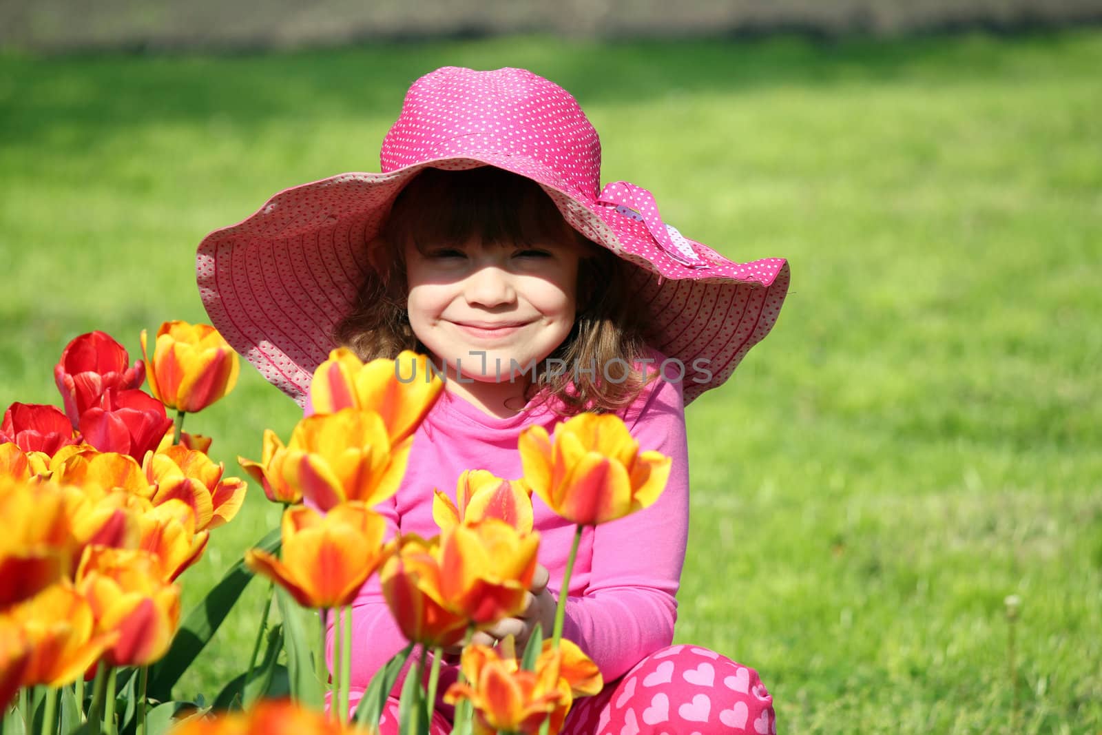 beautiful little girl with tulip flowers portrait by goce
