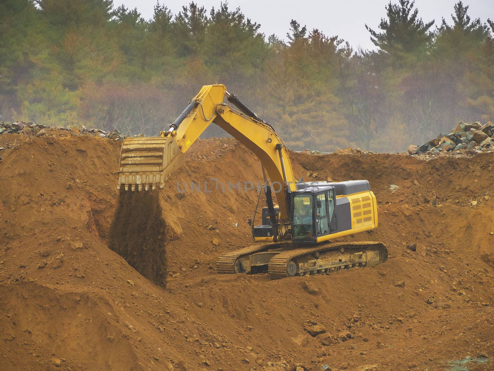 Excavator shovel digging in a gravel pit