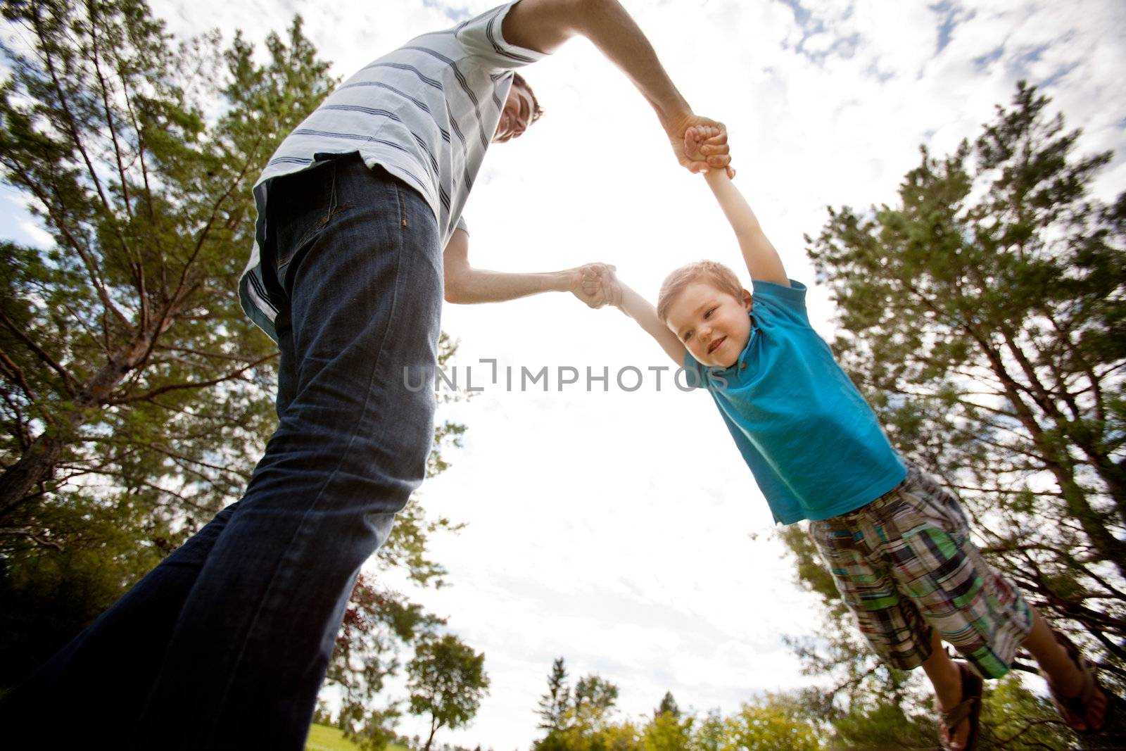 Father and Son Playing in Park by leaf