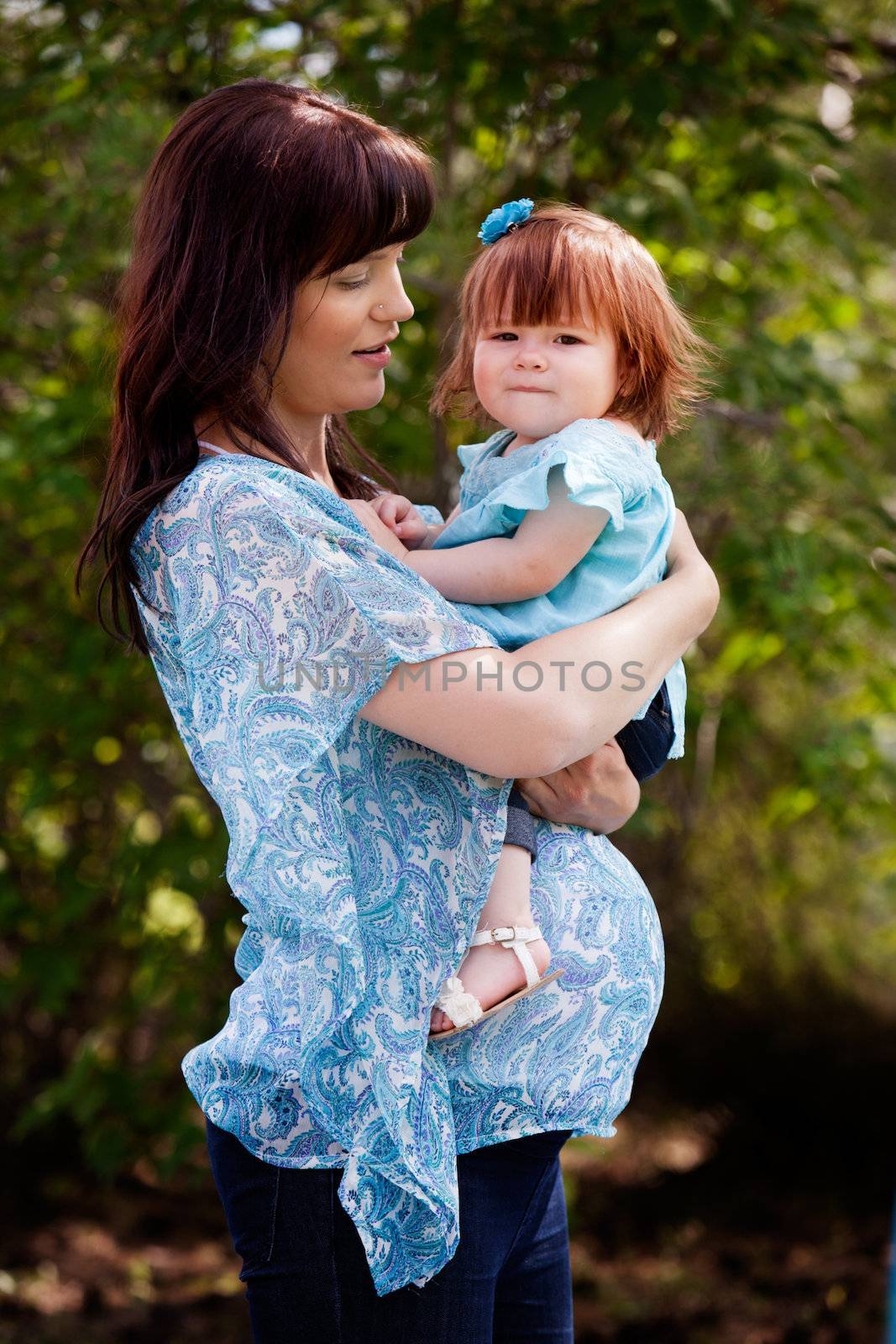 Pregnant Mother with Daughter by leaf