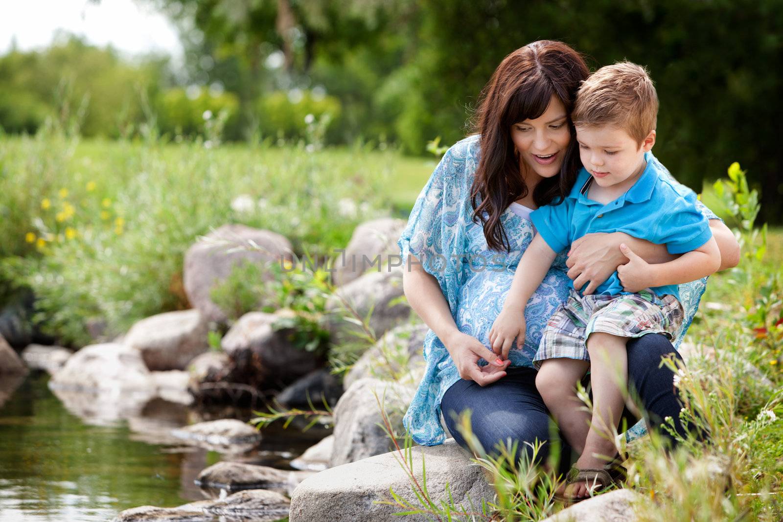 Mother and Son Playing Near Lake by leaf